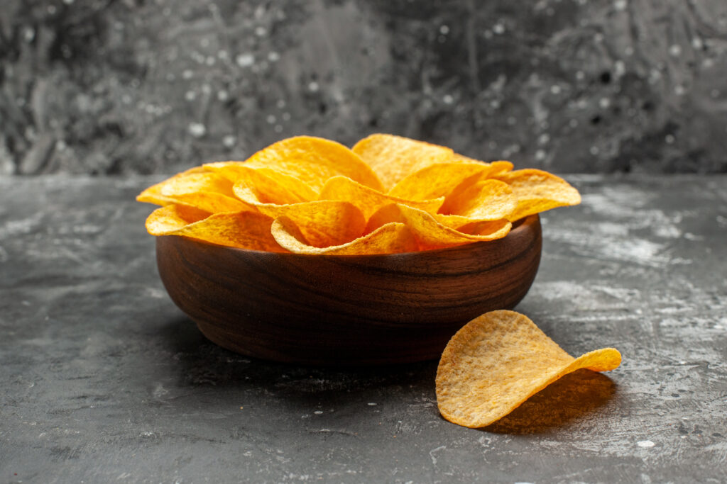 side close view chips bowl dark grey table with dark grey background