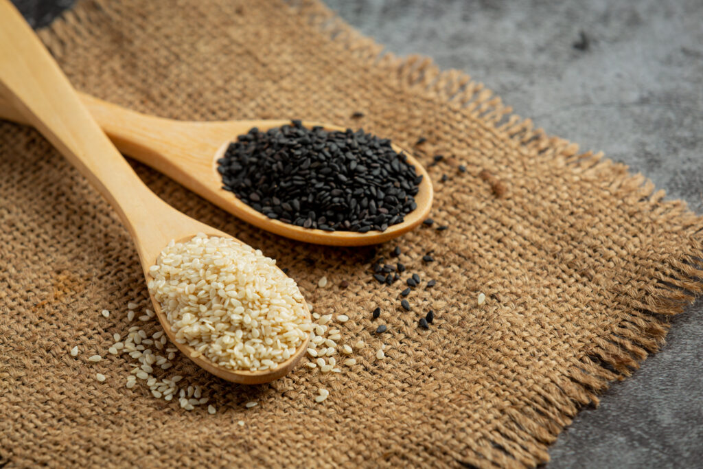 white sesame and black sesame on dark background